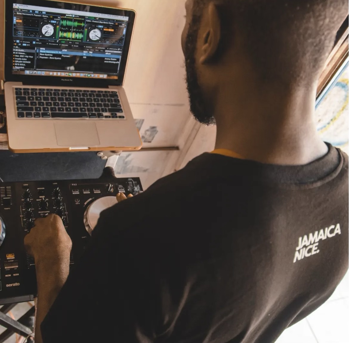 DJ Kenny at the controller and laptop, selecting music